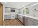 Modern kitchen with gray cabinets, stainless appliances, and bright lighting at 160 Oglesby Bridge Rd, Conyers, GA 30094