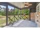 Relaxing screened porch featuring patterned floor, ceiling fan, and open views of the yard at 160 Oglesby Bridge Rd, Conyers, GA 30094