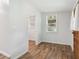 Small room with a wooden door and views to an adjacent room and back yard at 160 Oglesby Bridge Rd, Conyers, GA 30094