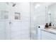A glass enclosed shower featuring tiled walls and recessed shelving at 1952 Maritime Way, Atlanta, GA 30318