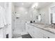Bright bathroom featuring a glass shower, white cabinetry, and granite counters at 1952 Maritime Way, Atlanta, GA 30318