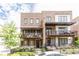 Beautiful brick townhome featuring a covered balcony and professionally landscaped front yard at 1952 Maritime Way, Atlanta, GA 30318