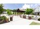 Outdoor grill area with built-in barbecue grills and picnic tables, surrounded by lush green landscaping at 1952 Maritime Way, Atlanta, GA 30318