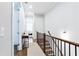 Upstairs hallway with hardwood floors, a staircase, and access to bedrooms and bathrooms at 1952 Maritime Way, Atlanta, GA 30318