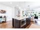 Spacious kitchen island with granite countertops, pendant lighting, and hardwood floors at 1952 Maritime Way, Atlanta, GA 30318