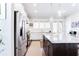 Bright kitchen with white cabinets, stainless steel appliances, a large island, and lots of natural light at 1952 Maritime Way, Atlanta, GA 30318