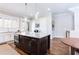 Kitchen island featuring dark cabinets and granite countertops, ideal for meal prep and entertaining at 1952 Maritime Way, Atlanta, GA 30318