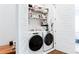 Laundry room with front loading washer and dryer and overhead storage at 1952 Maritime Way, Atlanta, GA 30318