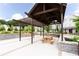 Shaded pavilion with wooden swings and a picnic table, set in a well-maintained community area at 1952 Maritime Way, Atlanta, GA 30318