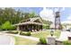 Inviting pool house and sitting area with comfortable lounge chairs, surrounded by manicured landscaping at 1952 Maritime Way, Atlanta, GA 30318