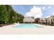 A relaxing community pool with lounge chairs for residents to enjoy, set among trees and other amenities at 1952 Maritime Way, Atlanta, GA 30318