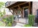 Inviting front porch with covered beams, a seating area and manicured landscaping at 1952 Maritime Way, Atlanta, GA 30318