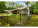 Fenced backyard with a view of the screened-in porch and the back of the home at 6865 Fletcher Dr, Winston, GA 30187