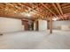 Unfinished basement featuring open wooden rafters and a concrete floor for versatile use at 6865 Fletcher Dr, Winston, GA 30187