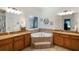 Double vanity bath with soaking tub, tile, and ample counter space at 6865 Fletcher Dr, Winston, GA 30187