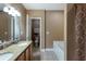 Well-lit bathroom with double vanity, granite countertop, tile flooring, and separate toilet area at 6865 Fletcher Dr, Winston, GA 30187