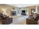 Bright living room featuring a stone fireplace and large windows for natural light at 6865 Fletcher Dr, Winston, GA 30187