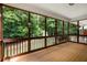 Relaxing screened porch with a view of the backyard and surrounding trees at 6865 Fletcher Dr, Winston, GA 30187