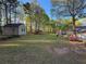 Expansive backyard with lush lawn, storage shed, and wooded area, perfect for outdoor activities at 2380 Emerald Dr, Loganville, GA 30052