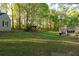 Home exterior with a spacious backyard featuring mature trees and ample green space at 2380 Emerald Dr, Loganville, GA 30052