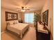 Cozy bedroom featuring neutral walls, ceiling fan, and plush carpet at 2380 Emerald Dr, Loganville, GA 30052
