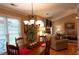 Dining room with a chandelier, wainscoting, and views of the living room at 2380 Emerald Dr, Loganville, GA 30052