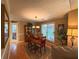 Formal dining room featuring wood floors, chandelier and a view into the living room at 2380 Emerald Dr, Loganville, GA 30052