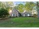 Charming brick home with a well-manicured lawn and mature trees offers inviting curb appeal at 2380 Emerald Dr, Loganville, GA 30052