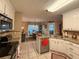 Bright kitchen with stainless appliances, granite counters and an adjacent breakfast area at 2380 Emerald Dr, Loganville, GA 30052