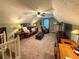 Upstairs living area features neutral walls, carpeting, sofa, and entertainment center at 2380 Emerald Dr, Loganville, GA 30052