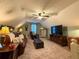 Upstairs living area features neutral walls, carpeting, sofa, and entertainment center at 2380 Emerald Dr, Loganville, GA 30052
