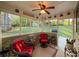 Relaxing sunroom with large windows offers serene views of the beautifully landscaped backyard at 2380 Emerald Dr, Loganville, GA 30052