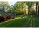 Beautiful home exterior with well-maintained lawn and vibrant azalea bushes at 2380 Emerald Dr, Loganville, GA 30052