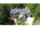 An aerial view of an estate, showcasing lush landscaping, brick driveway and well manicured lawn at 5178 S Trimble Rd, Atlanta, GA 30342