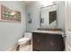 Powder room featuring granite countertop vanity, modern fixtures, and stylish artwork for a sophisticated touch at 5178 S Trimble Rd, Atlanta, GA 30342
