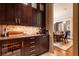 Butler pantry with wine fridge and custom cabinetry, adjacent to dining room at 5178 S Trimble Rd, Atlanta, GA 30342