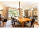 Formal dining room with hardwood floors, natural light, and elegant chandelier at 5178 S Trimble Rd, Atlanta, GA 30342