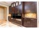 Gourmet kitchen featuring built-in stainless steel double ovens, custom cabinetry, and tile backsplash at 5178 S Trimble Rd, Atlanta, GA 30342