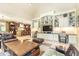 Open living room featuring custom shelving, a large flat-screen TV, and stylish furniture at 5178 S Trimble Rd, Atlanta, GA 30342