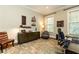 Inviting office with neutral paint, dark furniture, lots of sunlight, and a decorative area rug at 5178 S Trimble Rd, Atlanta, GA 30342