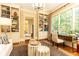 Bright home office featuring built-in shelving, a desk, and a large window with natural light at 5178 S Trimble Rd, Atlanta, GA 30342