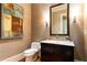 Stylish powder room with elegant fixtures, artwork, and decorative wallpaper at 5178 S Trimble Rd, Atlanta, GA 30342