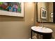 Chic powder room featuring a unique vessel sink, modern fixtures, and decorative artwork at 5178 S Trimble Rd, Atlanta, GA 30342