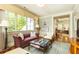 Comfortable sitting room with a plush sofa, a cozy chair, and views of the outside greenery at 5178 S Trimble Rd, Atlanta, GA 30342