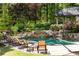 Relaxing backyard with inviting pool, waterfall feature, and lounge chairs surrounded by lush landscaping at 5178 S Trimble Rd, Atlanta, GA 30342