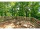 A wooden deck extends out over the lush yard, providing an ideal spot for outdoor entertaining or peaceful solitude at 5180 Stone Trce, Stone Mountain, GA 30083