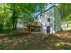 Expansive home exterior with a wooden deck, set amidst a lush, leafy backyard, perfect for outdoor enjoyment at 5180 Stone Trce, Stone Mountain, GA 30083