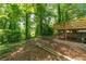 Spacious yard with a wooden deck, surrounded by lush greenery, offering a private outdoor space at 5180 Stone Trce, Stone Mountain, GA 30083