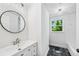 Bathroom with white vanity, black marble floors, and large mirror at 5180 Stone Trce, Stone Mountain, GA 30083