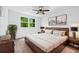 Warm bedroom with wood bed frame, plush carpets, and a bright window at 5180 Stone Trce, Stone Mountain, GA 30083